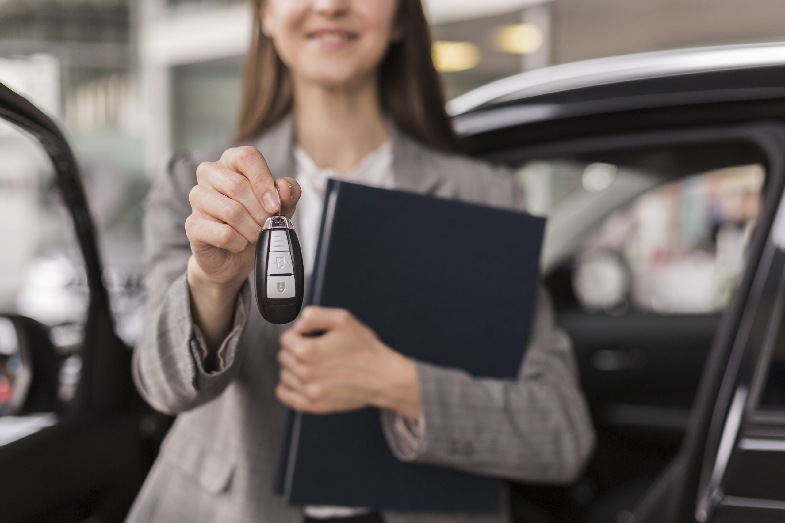 female-hands-holding-folder-car-keys